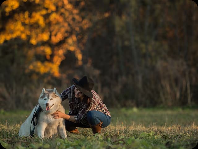 Person with husky dog in outdoor setting